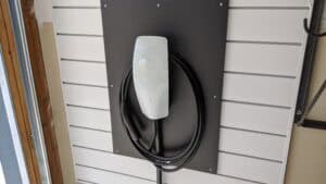 Tesla charger on a wall in a garage