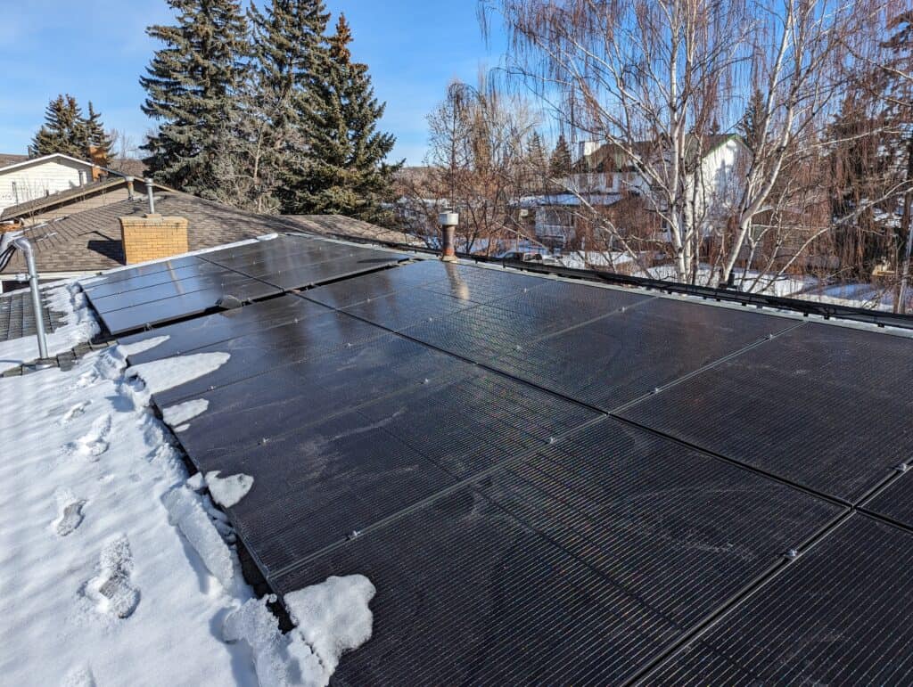 Solar panels on a Calgary home in winter with snow on the roof