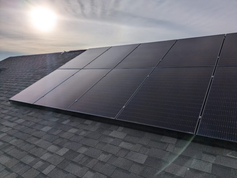 Solar panels Chestermere roof with the sun low in the sky