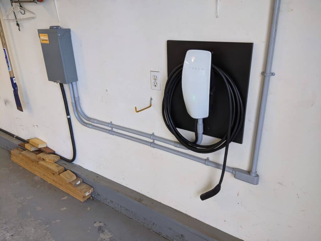 Certified Tesla electrician installing a Wall Connector in Calgary